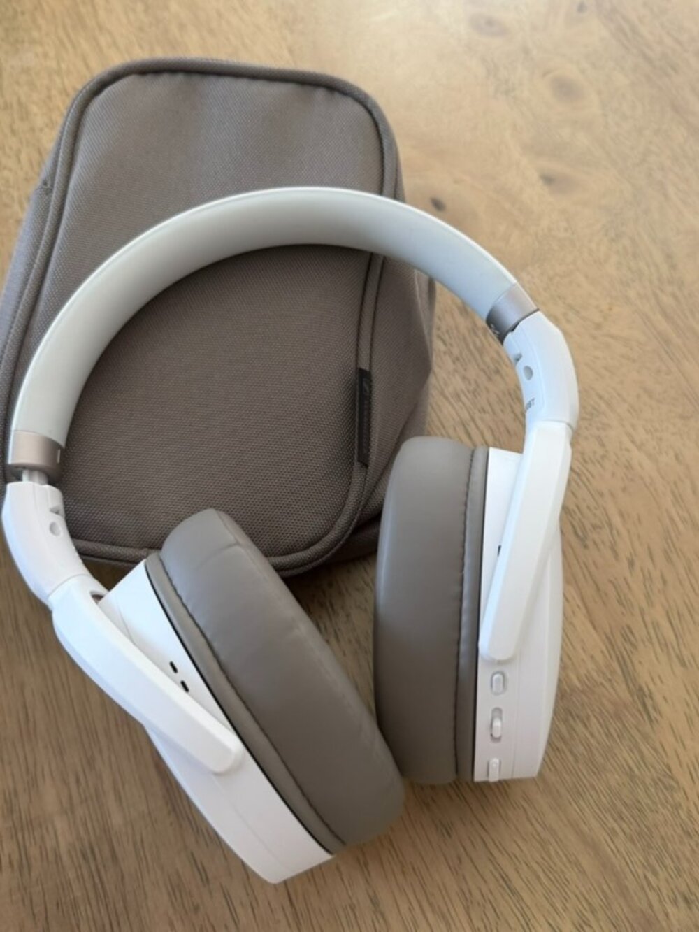 White Sennheiser HD 450BT wireless headphones featuring grey ear cushions.